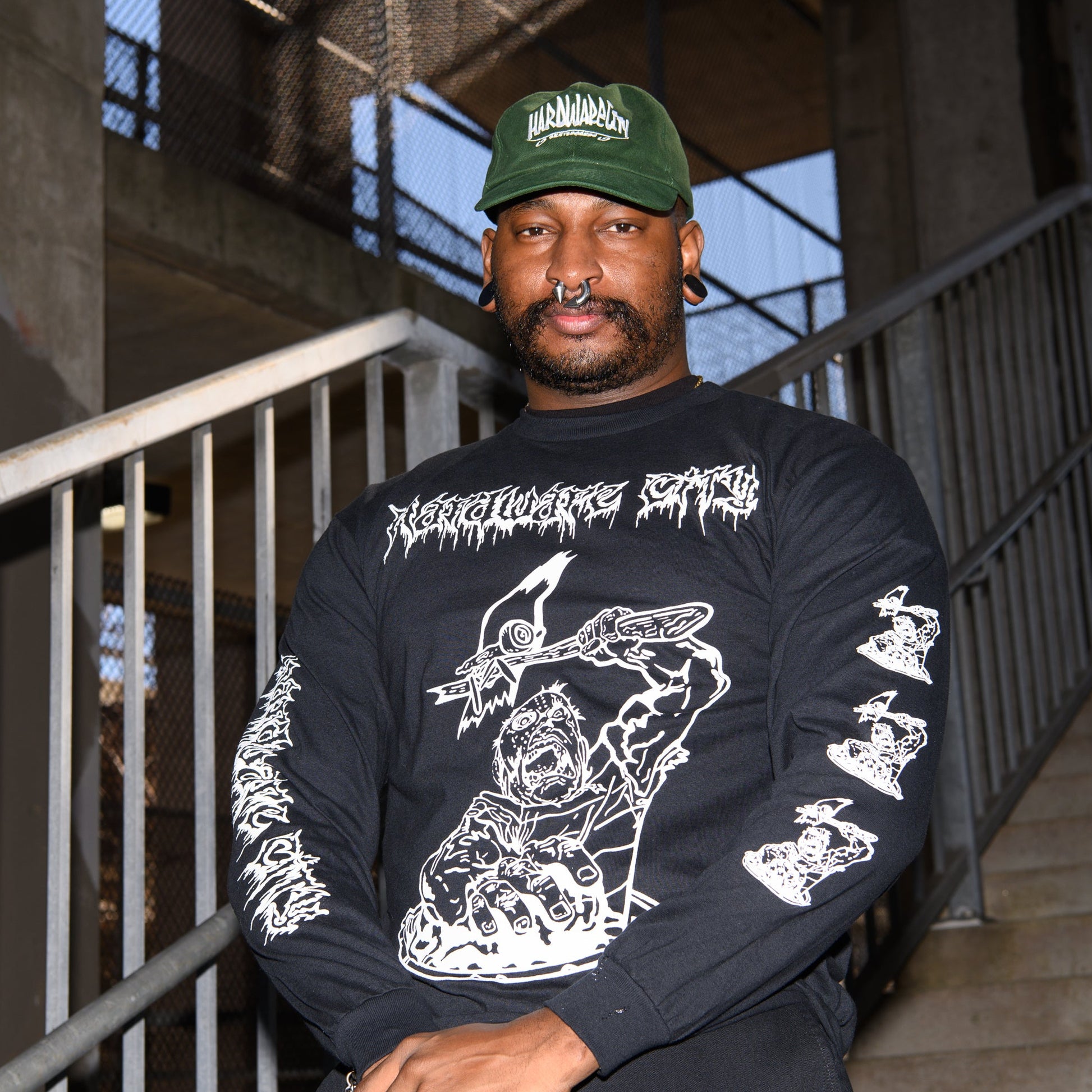 Carlwearing the Heavy Metal Hardware black long-sleeve shirt with white graphic.